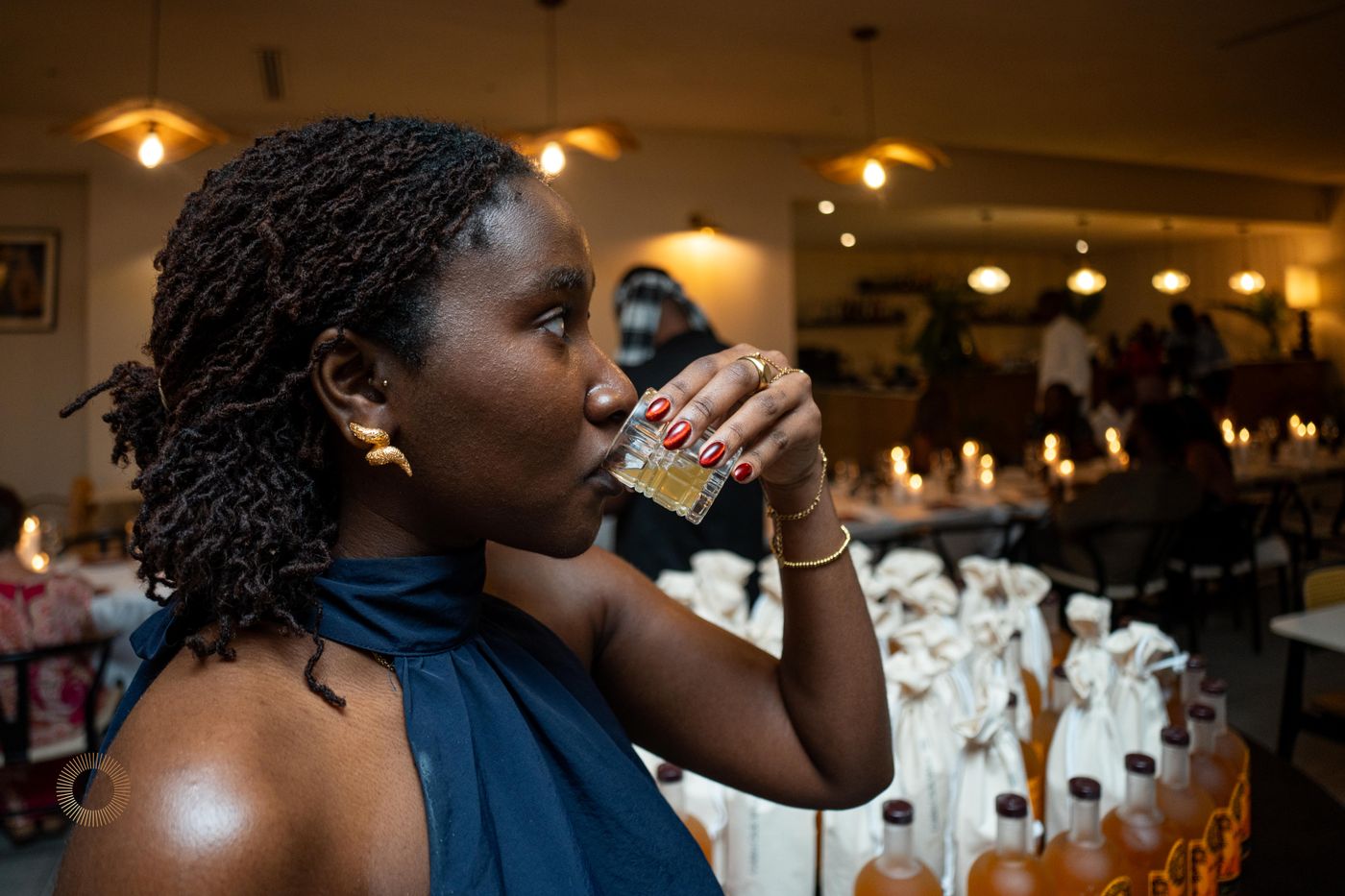 A woman tasting Aphro at a candlelit dinner event