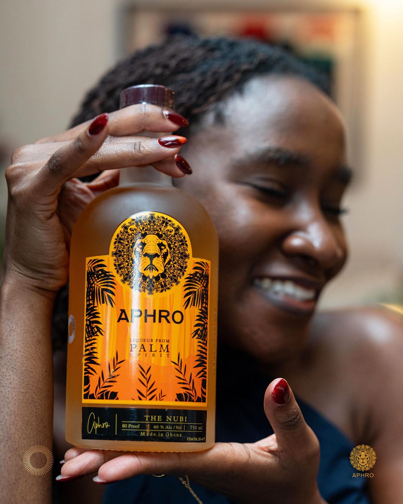 A woman smiling while holding a bottle of The Nubi