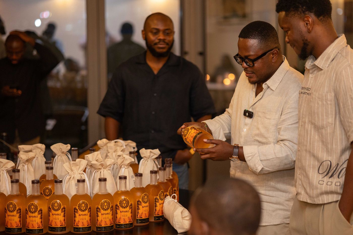 A guest examining a personalized Aphro bottle label at an event